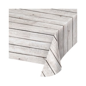 May include: White plastic tablecloth with a wood plank pattern. The tablecloth is rectangular and has a slightly rounded corner.