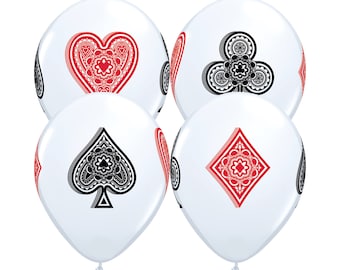 May include: Four white balloons with black and red playing card suit symbols. The suits are hearts, clubs, spades, and diamonds.
