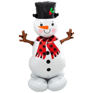 May include: A white snowman balloon with a black top hat, red and black plaid scarf, and brown arms. The snowman has a carrot nose, black eyes, and a red blush on its cheeks.