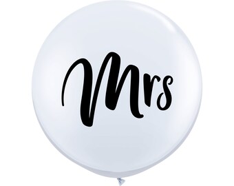 May include: White balloon with the word "Mrs." printed in black cursive lettering.