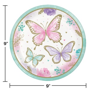 May include: A set of 9-inch round paper plates featuring a watercolor design of butterflies and flowers in shades of pink, purple, and teal. The plates have a gold trim and are perfect for a butterfly-themed party.