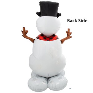 May include: A white snowman balloon with a black top hat, red and black plaid scarf, and brown twig arms. The balloon has a white snowflake pattern and is standing on two white round balloons. The text "Back Side" is visible in the image.
