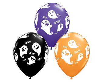 May include: Three Halloween party balloons with a ghost pattern. The balloons are purple, black, and orange. The ghosts have different expressions, including a winking ghost, a ghost with a heart, and a ghost with a surprised expression. The balloons have the word "BOO!" printed on them.