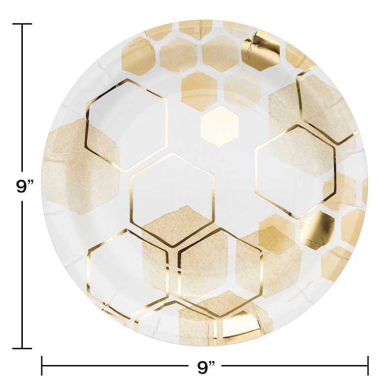 May include: White paper party plates with a gold honeycomb pattern. The plates are 9 inches in diameter.