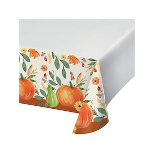 May include: A white plastic tablecloth with a brown border and a fall-themed design featuring pumpkins, gourds, leaves, and flowers.