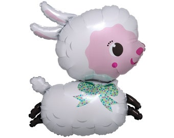 May include: A white and pink balloon shaped like a lamb with a green and white polka dot bow. The lamb has a pink face with black eyes and a pink nose.