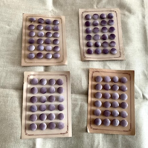 May include: Four cards each displaying 24 purple buttons. The buttons are arranged in a grid pattern on each card.