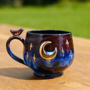 Handmade coffee mug night style with golden stars and moon, night sky