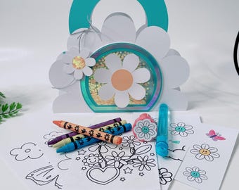 May include: A teal and white paper handbag-shaped shaker card featuring a daisy cutout, filled with yellow sequins. Included are several coloring sheets with flower and butterfly designs, a set of colorful crayons, a flower stamp, and a bubble wand.