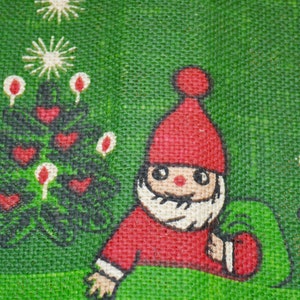 May include: A red and white Christmas gnome with a white beard and a red hat. The gnome is holding a red bag. The background is green with a Christmas tree design.