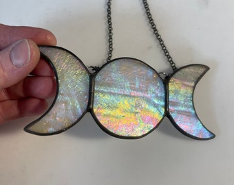 May include: A triple moon stained glass suncatcher with iridescent glass and a silver chain for hanging.