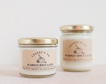May include: Two glass jars with gold lids, labeled "Leaves & Co Pumpkin Spice Latte." The labels are tan with a pumpkin illustration. The smaller jar contains 90 grams of wax and is made in France.