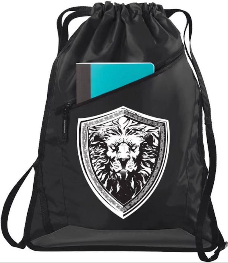 May include: Black drawstring bag with a zippered pocket and a white lion head graphic inside a shield. The bag has a gray bottom and white drawstrings.