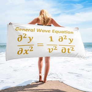 May include: A white rectangular beach towel featuring the text General Wave Equation in gold, followed by the mathematical formula for the general wave equation printed in gold, displaying partial derivatives with respect to space and time.