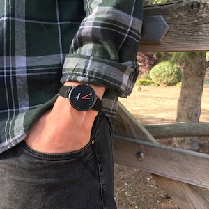 Black watch for men. Basic, minimalist and modern, with red hands and easily interchangeable leather strap.