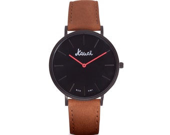 Men's watch with black dial and brown leather strap. Basic, minimalist, flat and modern, with red needles.