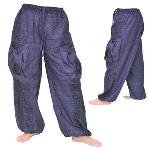 May include: A pair of dark blue, loose-fitting pants with black patterned designs. The pants have a drawstring waistband and two large cargo pockets on the sides.