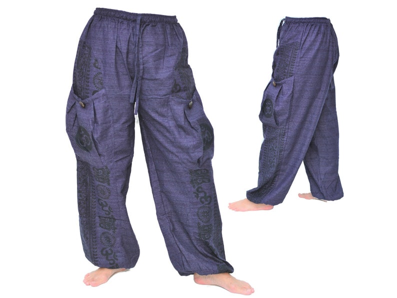 May include: A pair of dark blue, loose-fitting pants with black patterned designs. The pants have a drawstring waistband and two large cargo pockets on the sides.