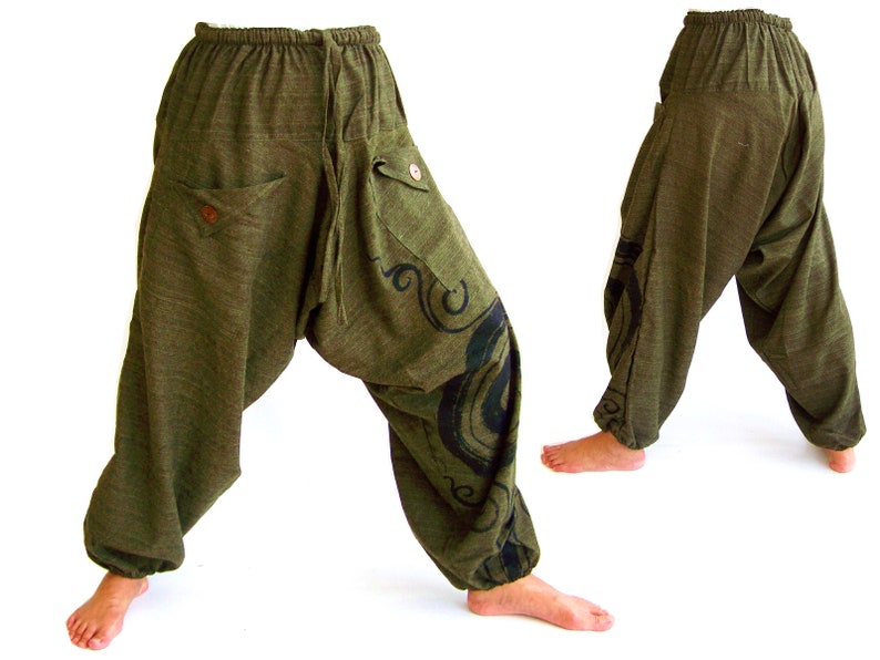 May include: Green, loose-fitting pants with a black and white design on the side. The pants have a drawstring waist and pockets.