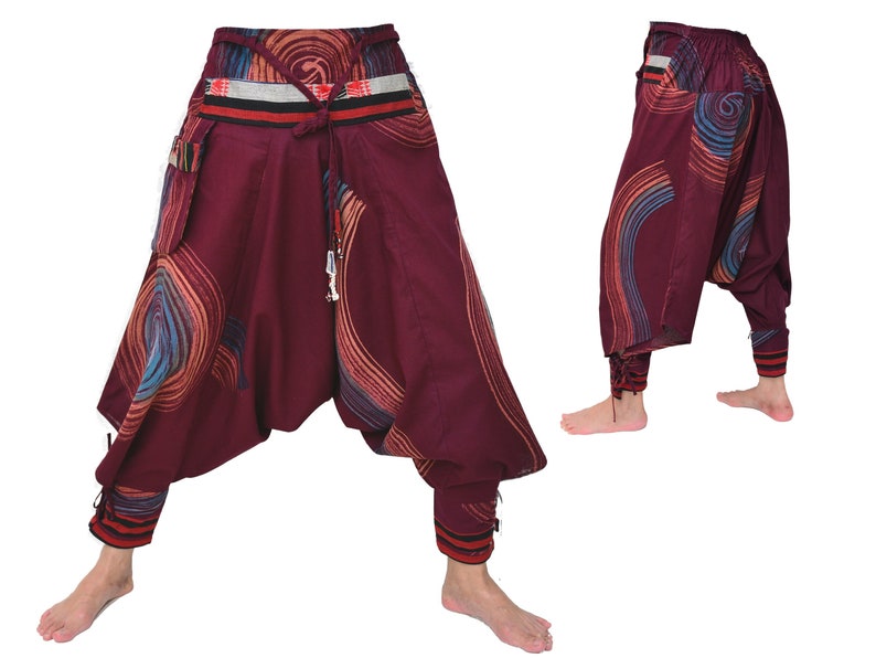 May include: Burgundy-colored pants with a colorful swirl pattern and a decorative waistband. The pants have a loose, flowing fit and are gathered at the ankles.