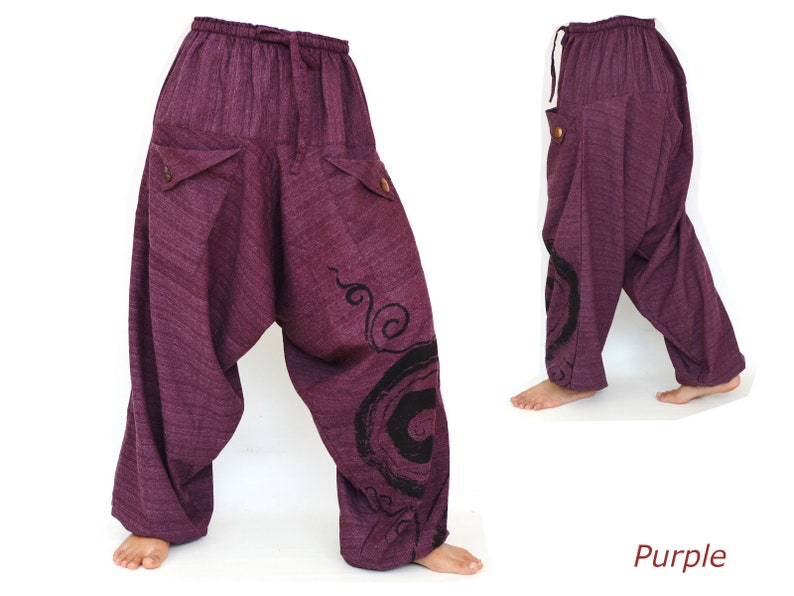 May include: Purple cotton pants with a swirling design on the right leg. The pants have a drawstring waist and two pockets on the front.