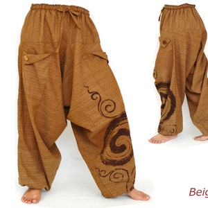 May include: Beige harem pants with a brown swirl design. The pants have a drawstring waist and two pockets.