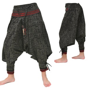 May include: Black and gray patterned pants with red and white trim. The pants have a loose, baggy fit and are gathered at the ankles with drawstrings.