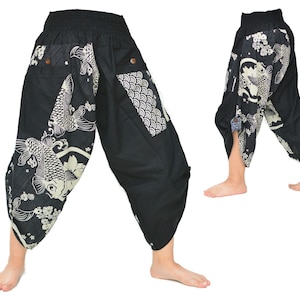 May include: Black pants with a white koi fish and floral print. The pants have a wide leg and a loose fit.