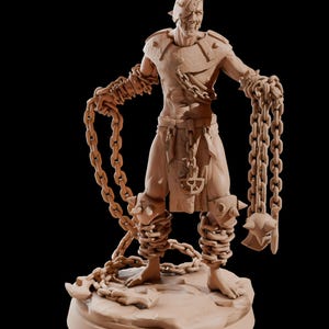 May include: A detailed miniature figurine of a chained, armored warrior with a spiked helmet and a menacing expression. The figure is sculpted in a light brown color and stands on a rocky base.