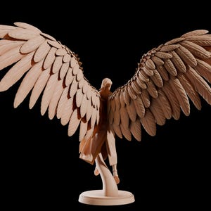 May include: A wooden sculpture of a figure with outstretched wings. The wings are detailed with individual feathers, and the figure is standing on a round base. The sculpture is a light brown colour against a black background.