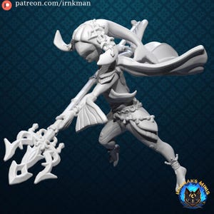 May include: A white 3D-printed figurine of a female character in a dynamic pose, holding a trident. The figure wears a detailed outfit with flowing elements and decorative accents. The figurine is set against a dark blue patterned background.