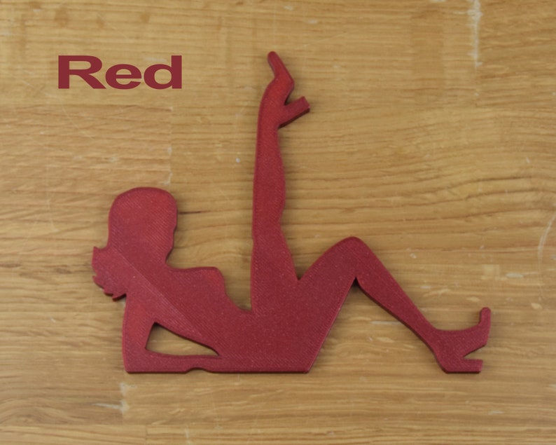 May include: Red silhouette of a woman in a reclining pose. The silhouette is made of a textured material.