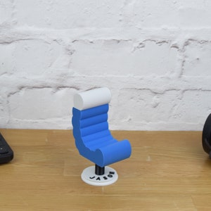 May include: A blue and white 3D printed chair with the name "Jason" printed on the base.
