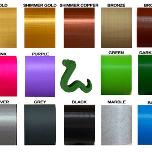 May include: A chart of 15 different colors of filament for 3D printing. The colors include gold, shimmer gold, shimmer copper, bronze, brown, pink, purple, green, dark green, silver, grey, black, marble, and blue.