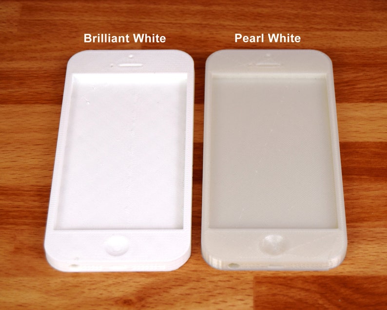 May include: Two white iPhone cases side-by-side. The case on the left is labeled "Brilliant White" and the case on the right is labeled "Pearl White".