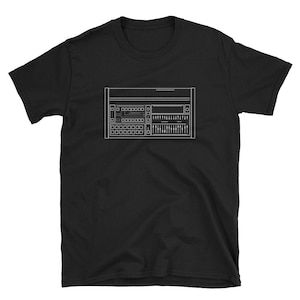 May include: Black t-shirt featuring a white line drawing of a synthesizer. The design includes various buttons, sliders, and a display, capturing the essence of electronic music production. A stylish and minimalist design for music enthusiasts.