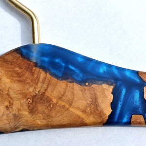 Design luxury coat hanger. Olive wood and royal blue epoxy resin