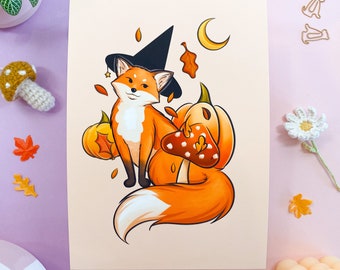 May include: An orange fox wearing a witch's hat and holding a mushroom sits next to a pumpkin. The fox has a white tail tip and is surrounded by autumn leaves.