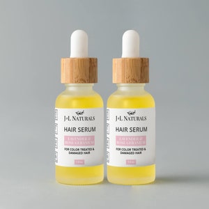 May include: Two amber glass bottles with bamboo lids and droppers filled with a yellow liquid. The bottles are labeled "J+L Naturals Hair Serum Lavender & Rose Geranium For Color Treated & Damaged Hair 1.0 oz."