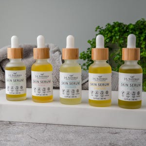 May include: Five glass bottles of skin serum with bamboo droppers and labels that say "J-L Naturals Skin Serum" with different names for each serum: Balance, Shine, Hydrate, Rejuvenate, and Calm. Each bottle is 1.0 fl oz / 30 ml.