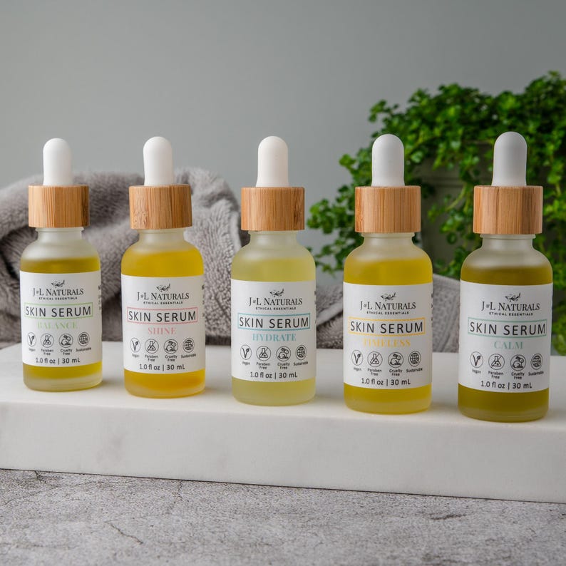 May include: Five glass bottles of skin serum with bamboo droppers and labels that say "J-L Naturals Skin Serum" with different names for each serum: Balance, Shine, Hydrate, Rejuvenate, and Calm. Each bottle is 1.0 fl oz / 30 ml.