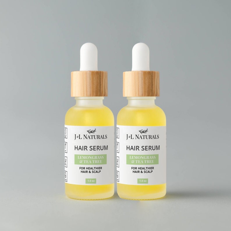 May include: Two amber glass bottles with bamboo caps and white labels. The labels read "J+L Naturals Hair Serum Lemongrass & Tea Tree For Healthier Hair & Scalp 1.0 oz".