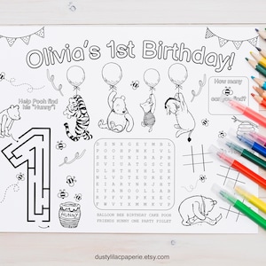 May include: Black and white coloring page with the text "Olivia's 1st Birthday!" featuring Winnie the Pooh characters, balloons, a maze, and a word search. Includes a set of colorful pencils.
