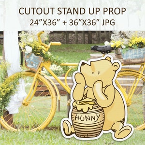May include: A cutout stand-up prop featuring Winnie the Pooh holding a honey pot. The prop is 61 cm by 91 cm and 91 cm by 91 cm. The background shows a yellow bicycle with flowers in a basket.