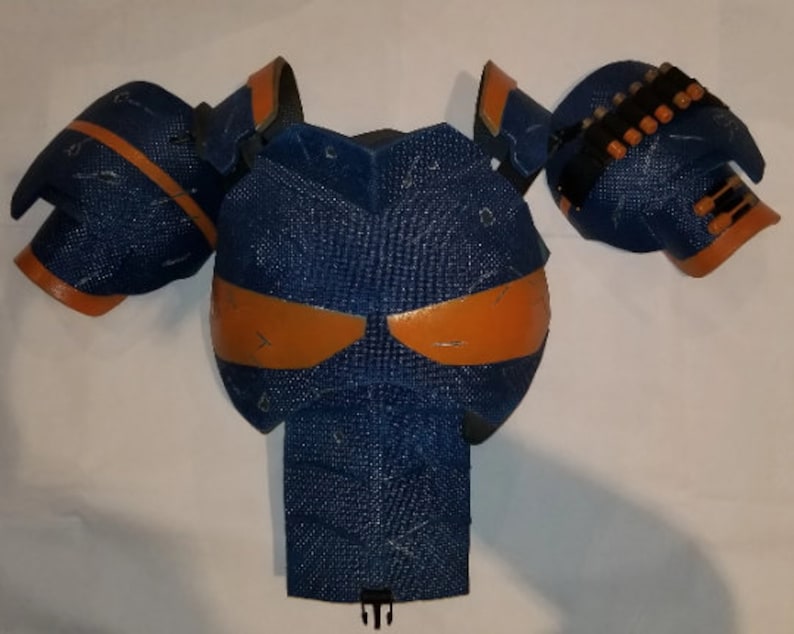 May include: Blue and orange padded armour for cosplay or costume. The armour is made of foam and has a textured surface.