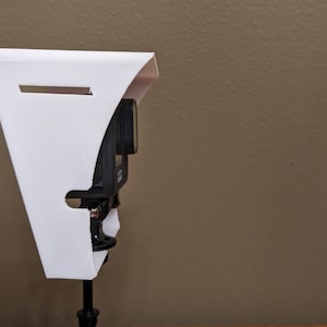 Side view of the GoPro shade with go-pro mounted.  You can see how the cable slot allows a charging cable to be used while the shade is in place.
