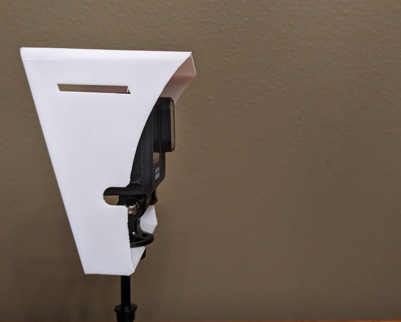 Side view of the GoPro shade with go-pro mounted.  You can see how the cable slot allows a charging cable to be used while the shade is in place.