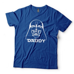 May include: A royal blue t-shirt with a white graphic of Darth Vader's helmet and the word "DADDY" underneath.