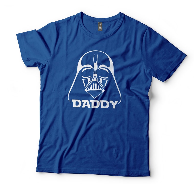 May include: A royal blue t-shirt with a white graphic of Darth Vader's helmet and the word "DADDY" underneath.