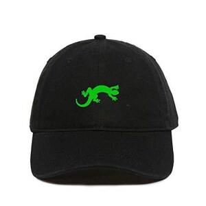 May include: A black baseball cap with a green lizard silhouette embroidered on the front.